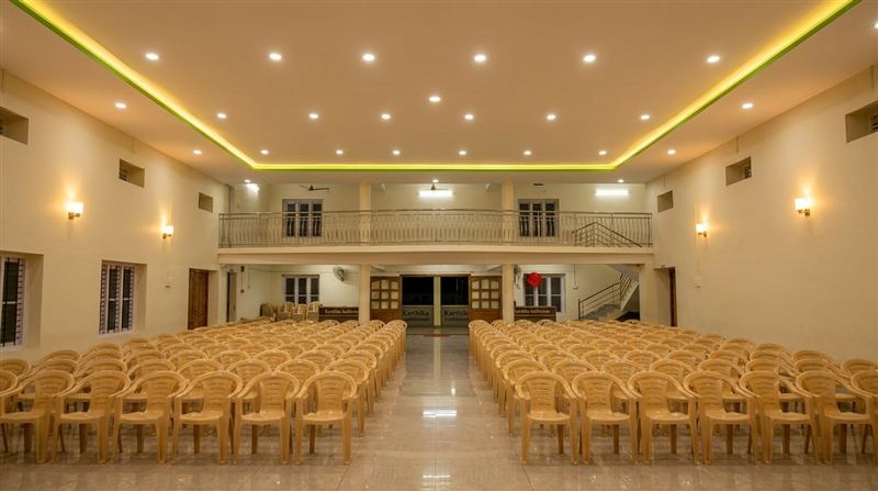 Main hall at night with warm cove lighting and balcony