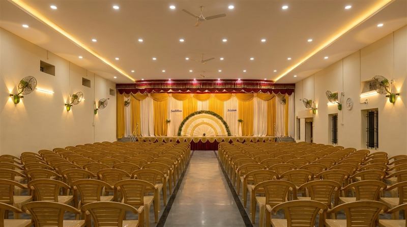 Hall with yellow and white stage decoration in sunburst pattern