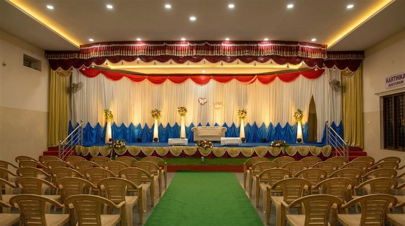 Wide stage with couple's couch and blue-white drapes