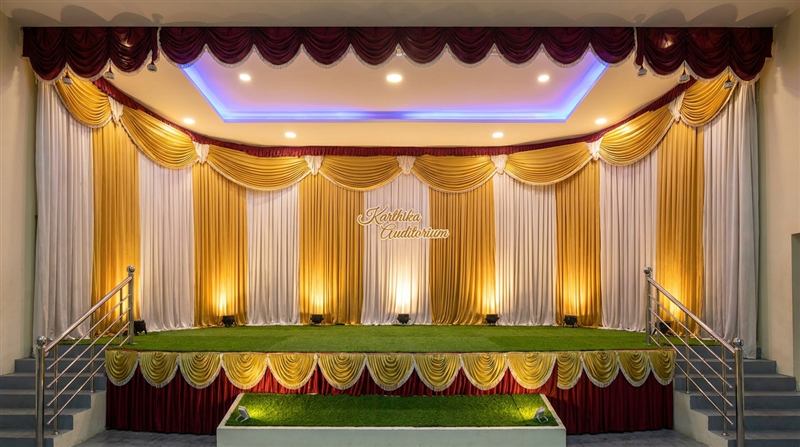 Stage decorated in red, white and blue with brass lamp